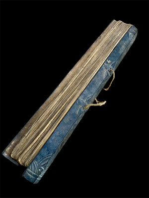 Sinhalese palm (ola) leaf book, ca. early 20th century CE. South Asia. Religious text from a Hindu-Buddhist monastery. Contains 60 leaves bound by two cords between a pair of wood slat covers. Measurements: Length 56 cm (22") x height 7.5 cm (3") x width 4.5 cm (1.75")