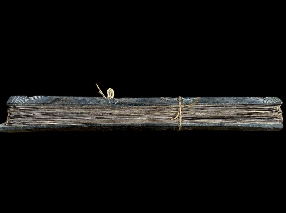 Sinhalese palm (ola) leaf book, ca. early 20th century CE. South Asia. Religious text from a Hindu-Buddhist monastery. Contains 60 leaves bound by two cords between a pair of wood slat covers. Measurements: Length 56 cm (22") x height 7.5 cm (3") x width 4.5 cm (1.75")