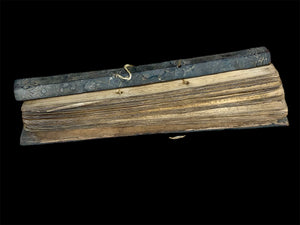 Sinhalese palm (ola) leaf book, ca. early 20th century CE. South Asia. Religious text from a Hindu-Buddhist monastery. Contains 60 leaves bound by two cords between a pair of wood slat covers. Measurements: Length 56 cm (22") x height 7.5 cm (3") x width 4.5 cm (1.75")