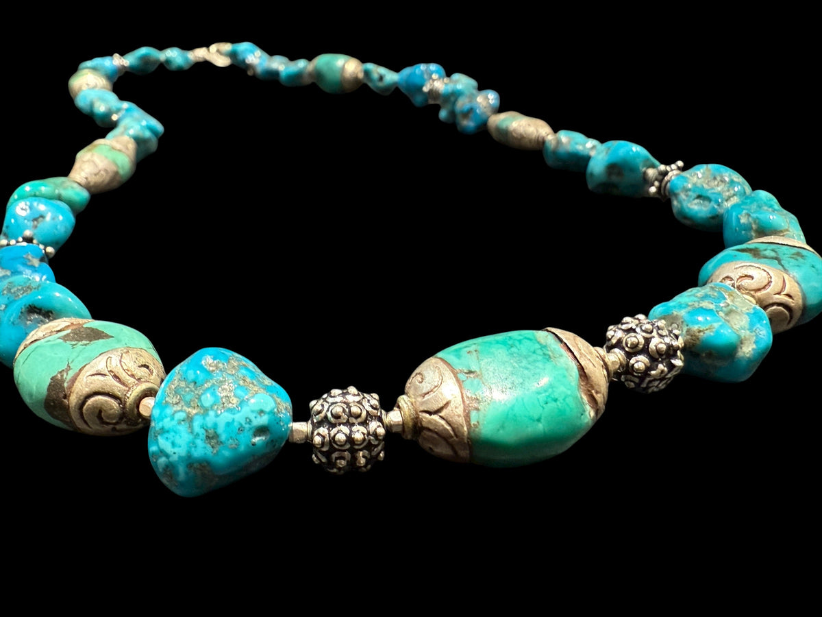Necklace of Arizona turquoise and vintage Tibetan silver capped turquoise beads. Heavy handmade sterling silver beads from India complete the look. Length 60 cm