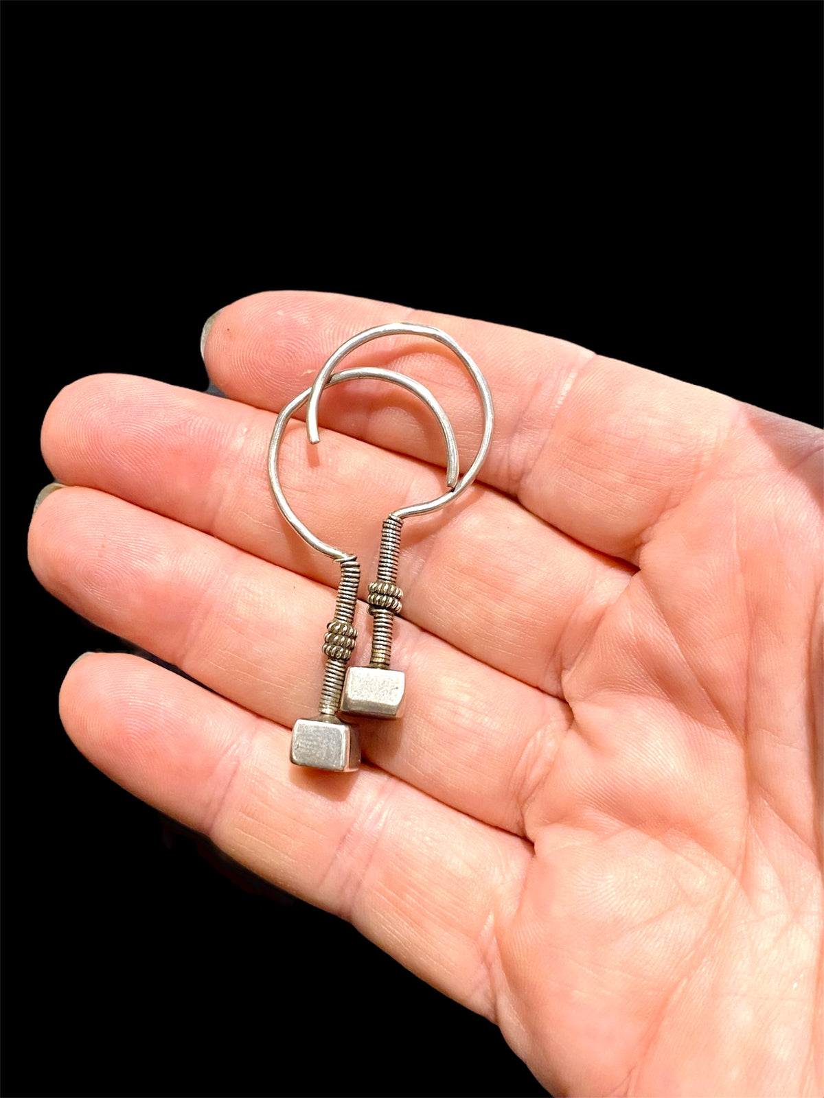 Rabari tribal earrings. High grade silver. Early 20th century. Traditionally worn in both the ear lobe and in the upper cartilage of the ear. Rabari, north east India. Measurements: length 4.5 cm, box pendant at end 0.6 x 1 0.5 cm