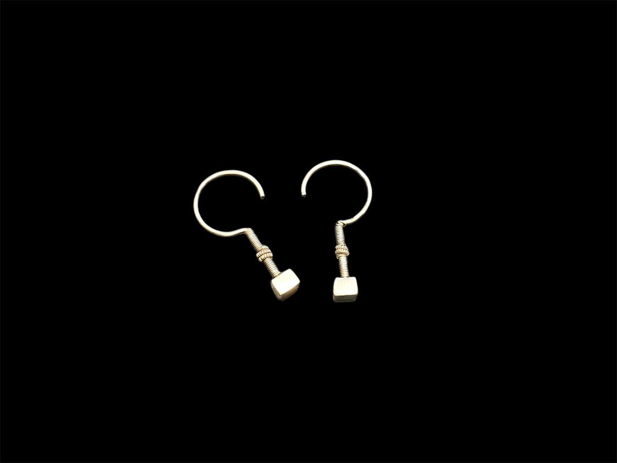 Rabari tribal earrings. High grade silver. Early 20th century. Traditionally worn in both the ear lobe and in the upper cartilage of the ear. Rabari, north east India. Measurements: length 4.5 cm, box pendant at end 0.6 x 1 0.5 cm