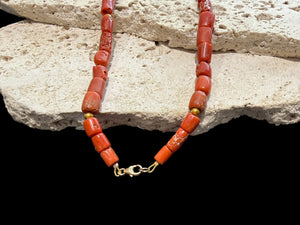 Graduated antique red coral from the Himalayas. The necklace features solid 22k gold bead highlights and a 9k gold clasp. Length 39.7 cm.