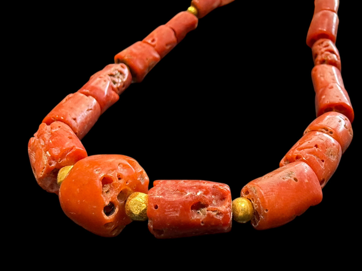Graduated antique red coral from the Himalayas. The necklace features solid 22k gold bead highlights and a 9k gold clasp. Length 39.7 cm.