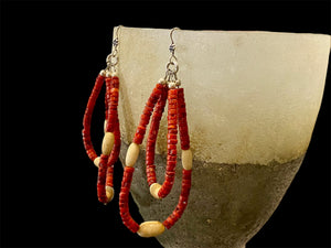 Long tribal earrings, two nested teardrop hoops of coral and buffalo bone beads, finished with sterling silver beads and hooks.  Total 9 cm length