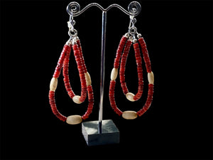 Long tribal earrings, two nested teardrop hoops of coral and buffalo bone beads, finished with sterling silver beads and hooks.  Total 9 cm length