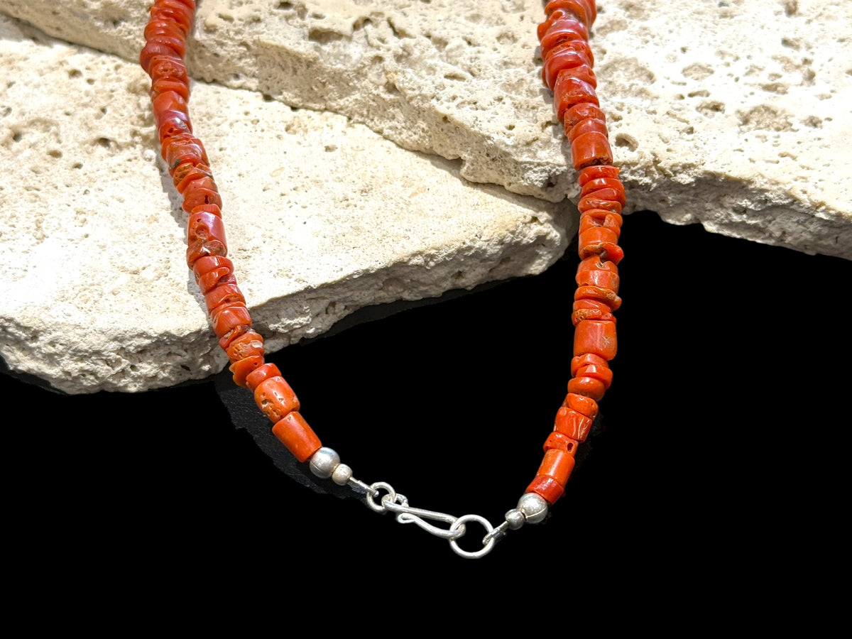 Necklace of graduated antique red coral from the Himalayas, finished with an antique silver bead and sterling silver clasp. Length 42.5 cm