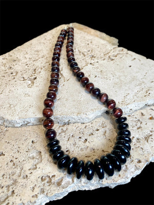 Natural tigers eye necklace features red tigers eye, with a centrepiece of graduated black onyx rondel beads and sterling silver detailing, length 46.5 cm