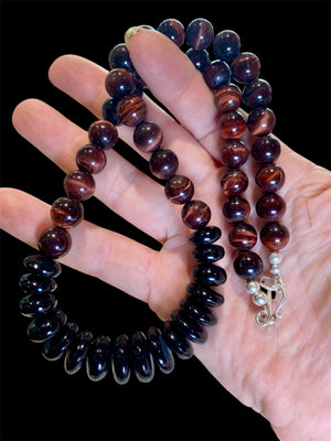 Natural tigers eye necklace features red tigers eye, with a centrepiece of graduated black onyx rondel beads and sterling silver detailing, length 46.5 cm