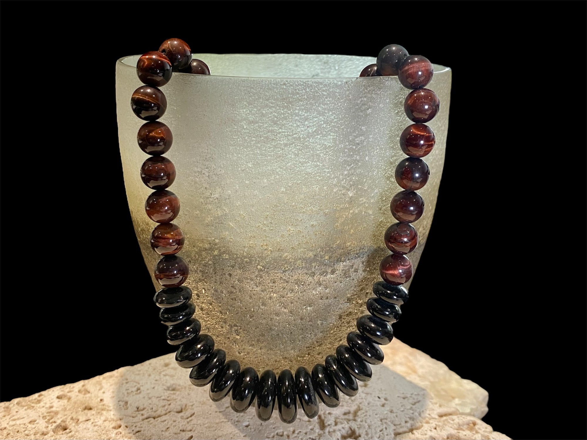 Natural tigers eye necklace features red tigers eye, with a centrepiece of graduated black onyx rondel beads and sterling silver detailing, length 46.5 cm