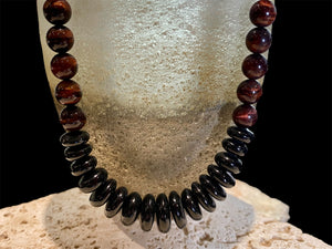 Natural tigers eye necklace features red tigers eye, with a centrepiece of graduated black onyx rondel beads and sterling silver detailing, length 46.5 cm