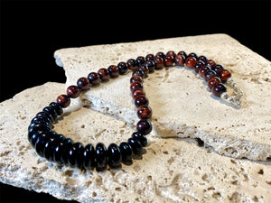 Natural tigers eye necklace features red tigers eye, with a centrepiece of graduated black onyx rondel beads and sterling silver detailing, length 46.5 cm