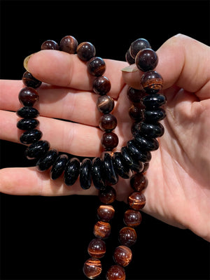 Natural tigers eye necklace features red tigers eye, with a centrepiece of graduated black onyx rondel beads and sterling silver detailing, length 46.5 cm