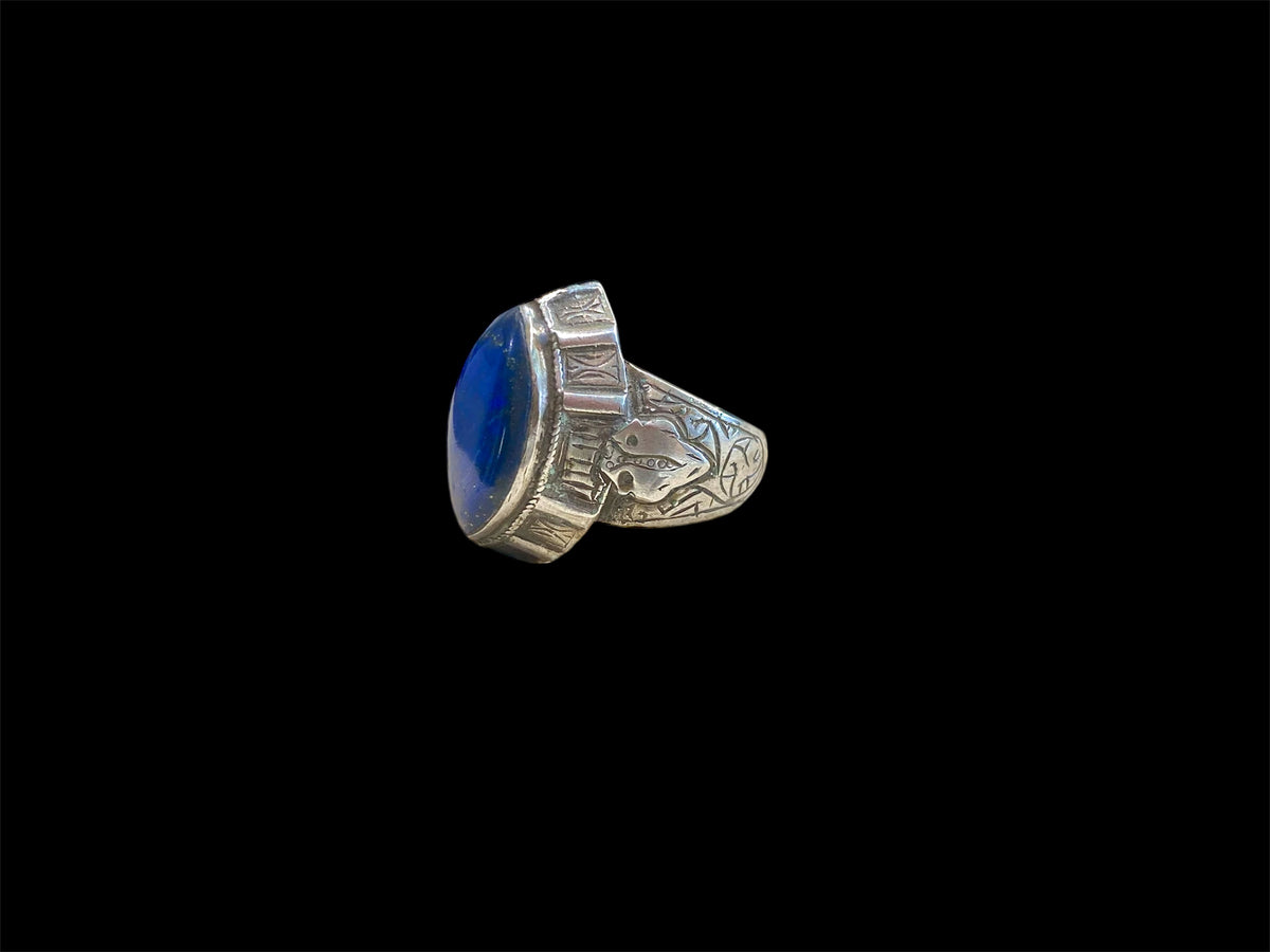 This classic Afghan ring features a large lapis lazuli stone and is made from sterling silver. From Afghanistan. Measurements: Ring face 2.7 x 2.4 cm