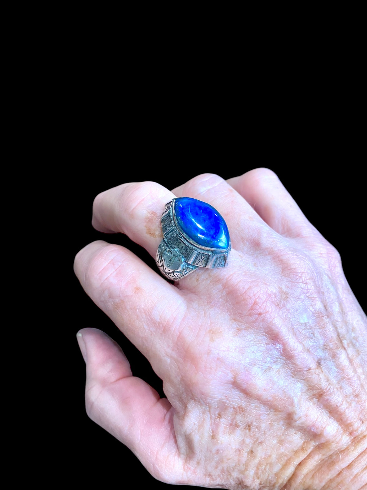 This classic Afghan ring features a large lapis lazuli stone and is made from sterling silver. From Afghanistan. Measurements: Ring face 2.7 x 2.4 cm