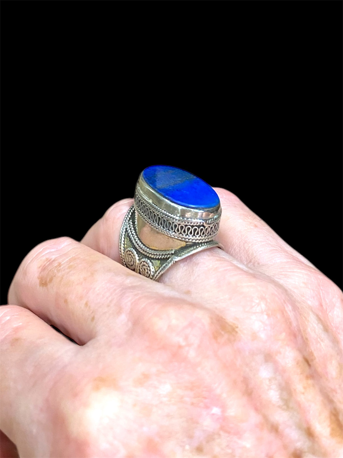 Turkoman ring features a lapis stone. Sterling silver with 24K gold wash. Turkmenistan. Measurements: Ring face 2.5 x 1.6 cm, Sizing: US Size 7.5 | 17.75 mm
