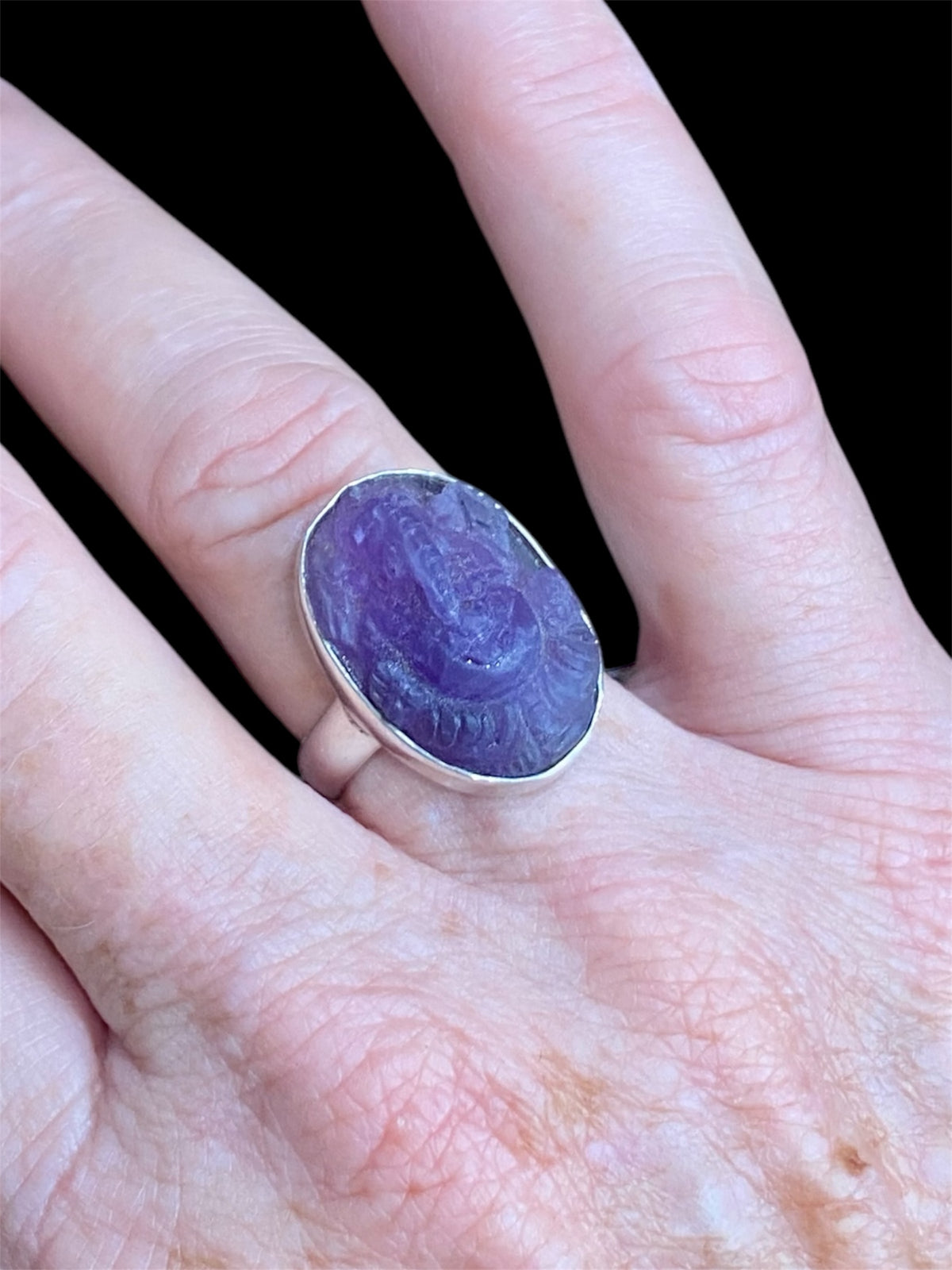 Carved amethyst ring featuring Ganesh, set in sterling silver. Measurements: Stone length 2.2 cm, width 1.5 cm US Size 7 | Inside diameter 17.35 mm