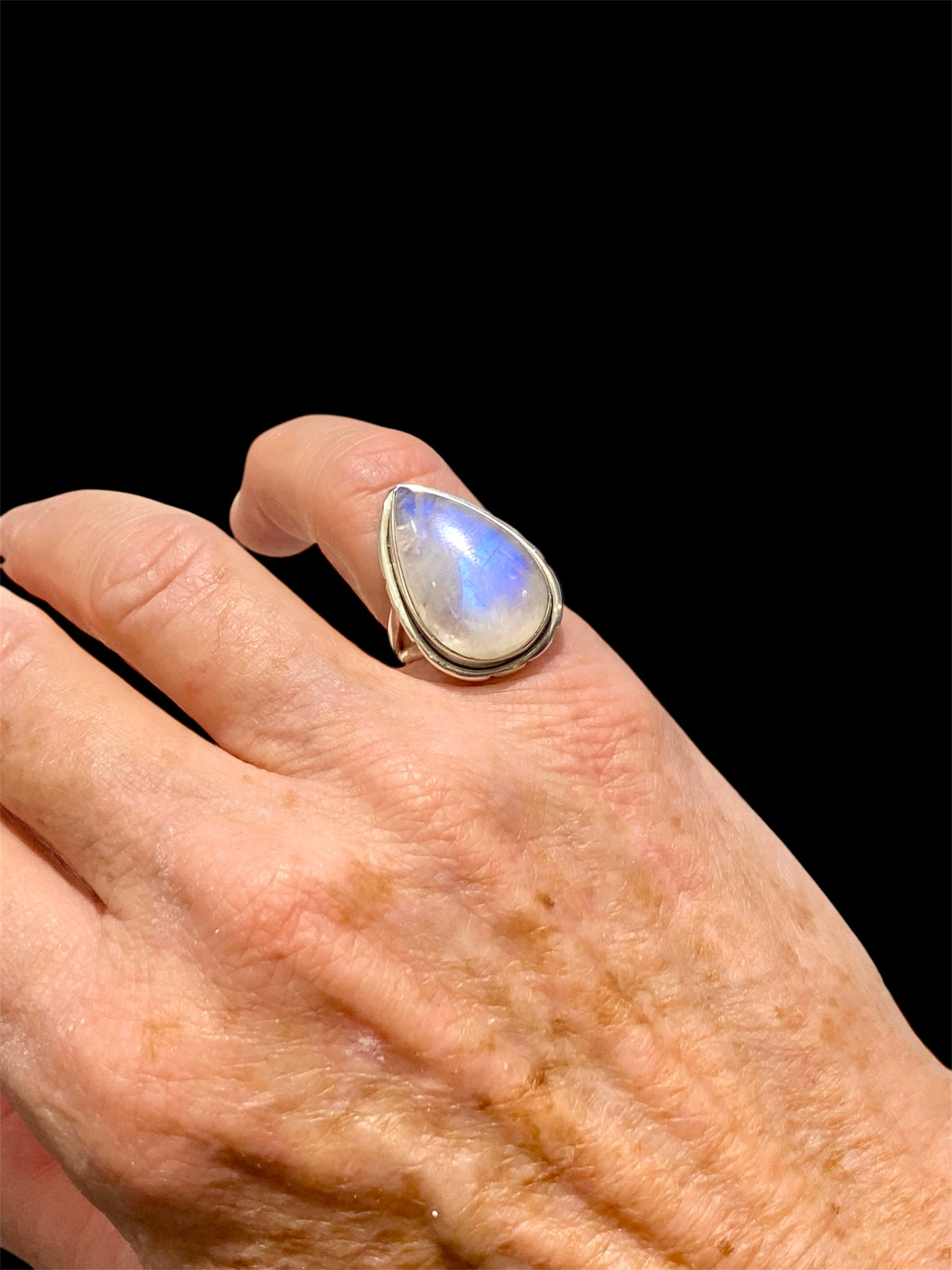 Teardrop rainbow moonstone ring set in sterling silver. Hand made in Jaipur, India. Measurements: Length of stone including bezel 2.5 cm (1 in), width 1.6 cm. Size 6 | 16.5 mm