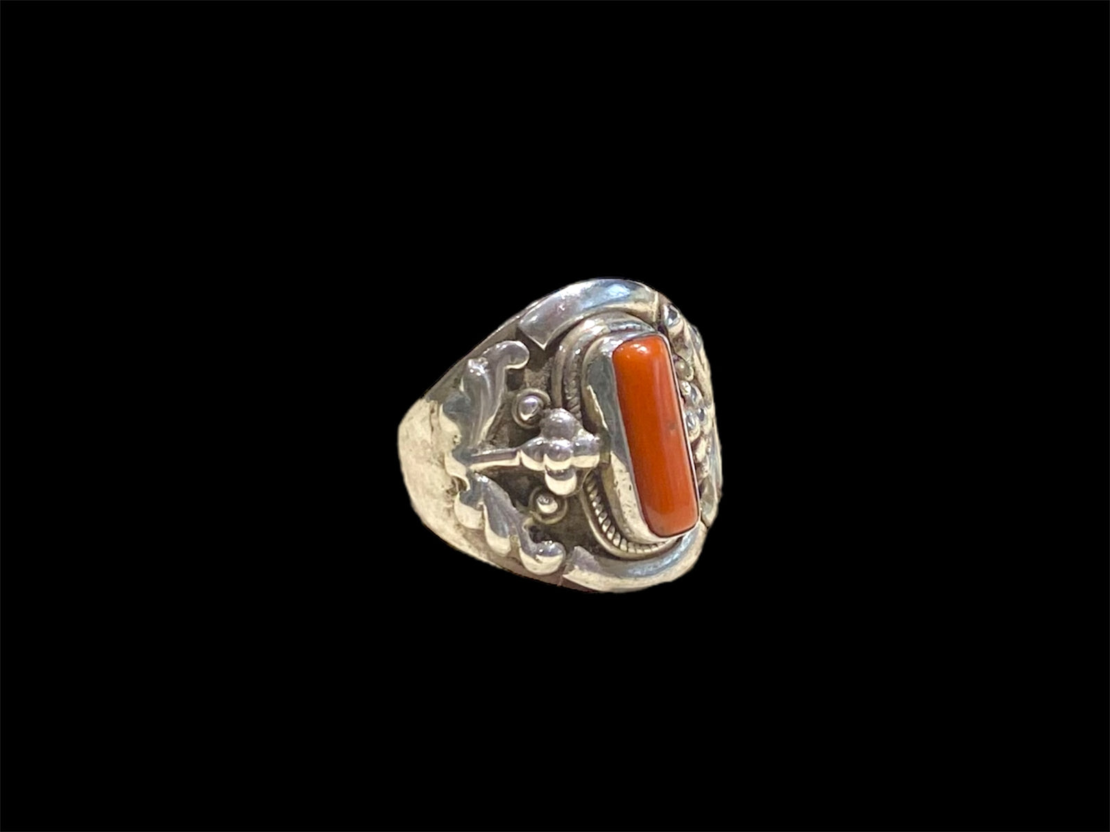 Beautifully detailed, petite ring set with a cabochon cut coral stone. Sterling silver. Handmade in Nepal. Measurements: Length of face 2 cm. Size 7.25 | 17.75 mm