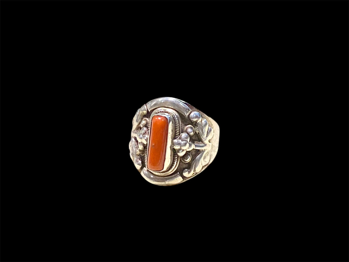 Beautifully detailed, petite ring set with a cabochon cut coral stone. Sterling silver. Handmade in Nepal. Measurements: Length of face 2 cm. Size 7.25 | 17.75 mm
