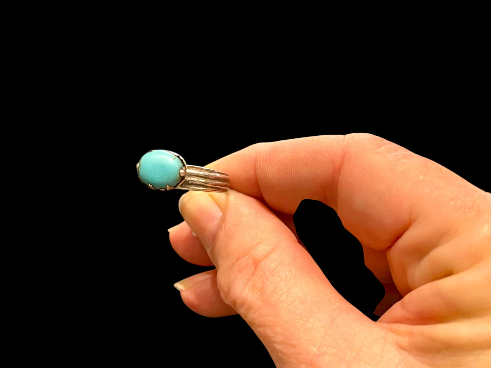 This unusual ring features an oval turquoise stone, set in a very high conical mount over a slender band. The turquoise stone is of excellent quality and contains very little matrix. Central Asia. Circa 1930. Stone 1 x 0.8 cm. Size 7 | 17.5 mm