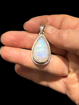 Teardrop rainbow moonstone pendant set in a scalloped sterling silver mount with a generous bail. Length including bail 4 cm, width 1.9 cm