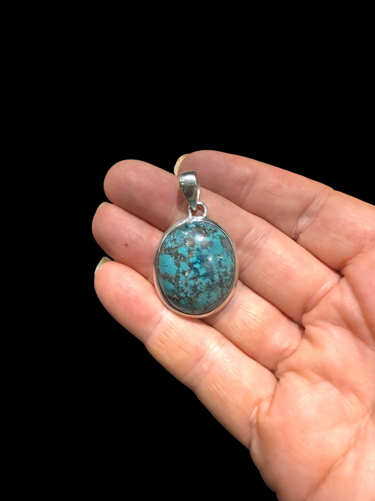 Large turquoise pendant with sterling silver bezel and bail.  Height 4 cm including bail, pendant 3 x 2.4 cm