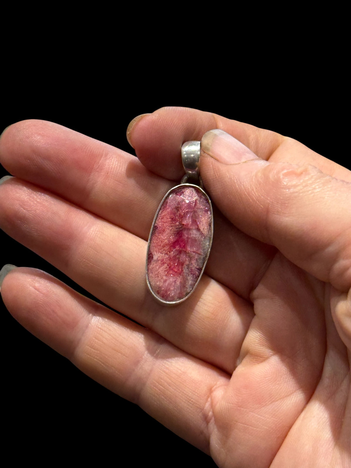 Our ruby pendant features a large facet cut stone set in sterling silver, height 4 cm including bail, width 1.2 cm.