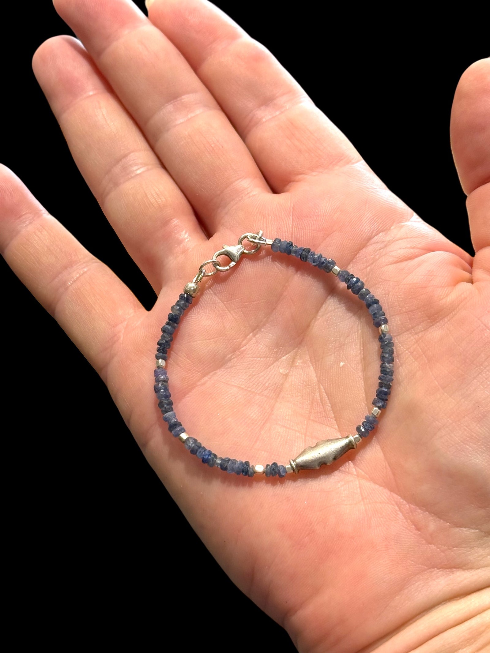 Fine beaded bracelet of facet cut sapphire, finished with a vintage sterling silver feature bead, spacer beads and clasp. Length 16.2 cm, size 14 cm.