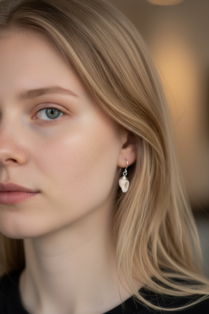 Simple and petite natural shell earrings finished with sterling silver mounts and hooks. Length including hook 2.7 cm