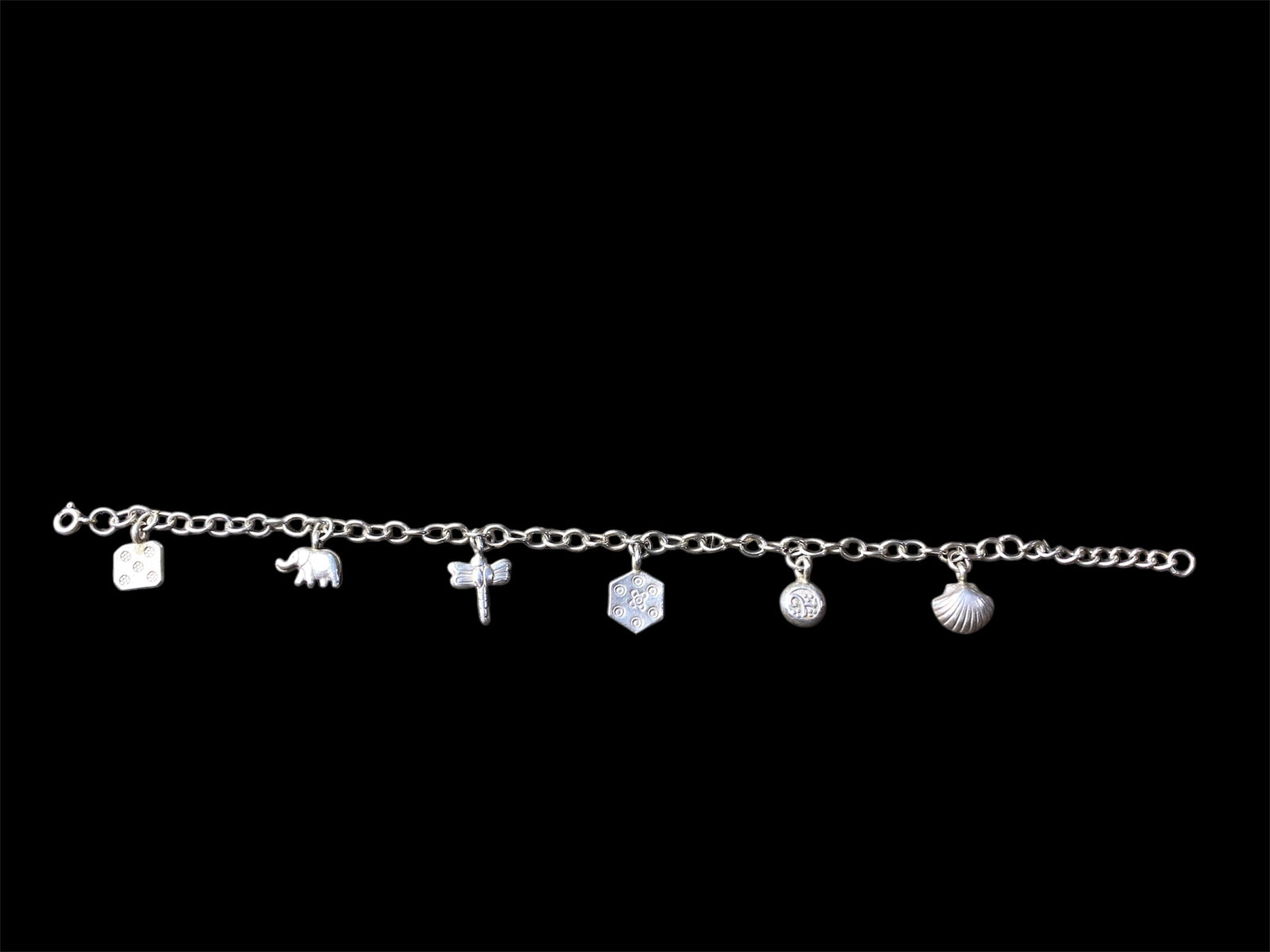 Sterling silver charm bracelet with 6 charms including elephant, dragonfly and seashell, with room to add more charms. With extension chain. Length 17.5 cm, with extension chain 22 cm 
