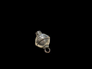 Unique tribal bead with two offset bails. Copper and silver, small glass bead set at one end. Early 20th C, northern India. Length 2.7 cm, diameter 1.7 cm.