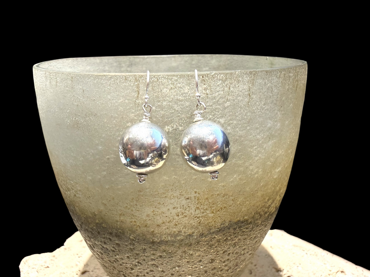 Elegant, simple earrings feature a ball shape. Sterling silver. Measurements: 3 cm length including hook