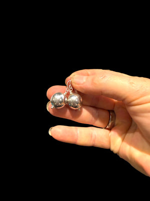 Elegant, simple earrings feature a ball shape. Sterling silver. Measurements: 3 cm length including hook