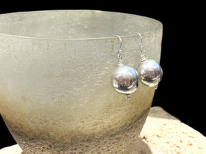 Elegant, simple earrings feature a ball shape. Sterling silver. Measurements: 3 cm length including hook