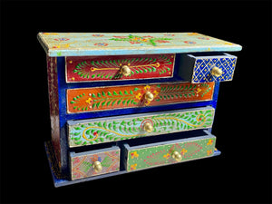 Hand painted chest of drawers features six drawers of varying sizes. Petite feet and polished brass knobs as handles. Small and compact, it is an ideal choice for storing a variety of items. Width 24 cm, depth 10 cm, height 17.5 cm
