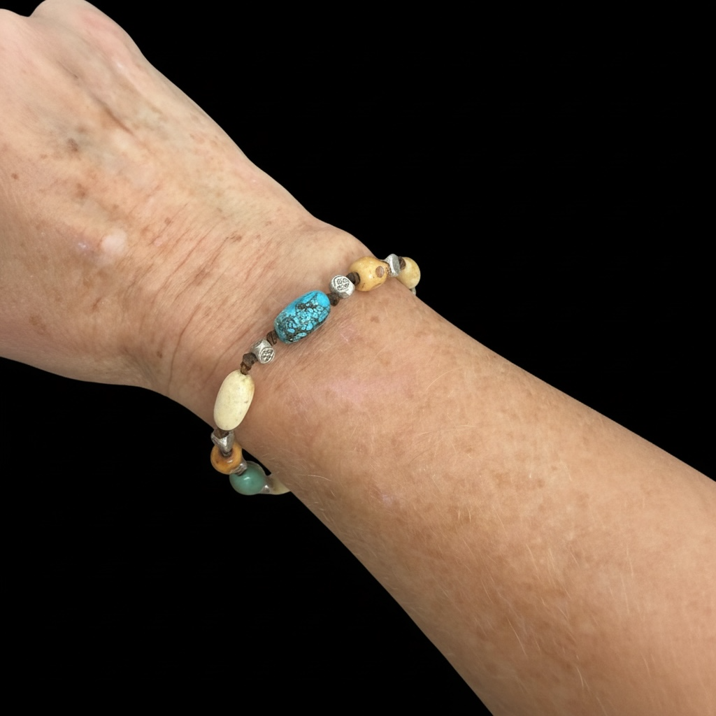 Yak bone skull beads, antique Tibetan turquoise, vintage Kachin bone and Karen hill tribe silver. Strung on sturdy waxed cord and adjustable. 20 cm or larger