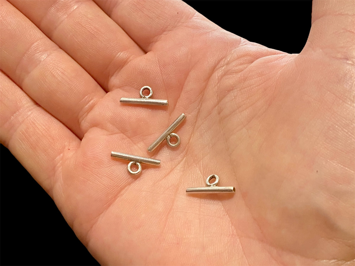 Small sterling silver toggle bars. For finishing necklace ends with toggle clasps. Choose from plain or fancy.

Price is per piece.

Measurements: length 1.8 cm