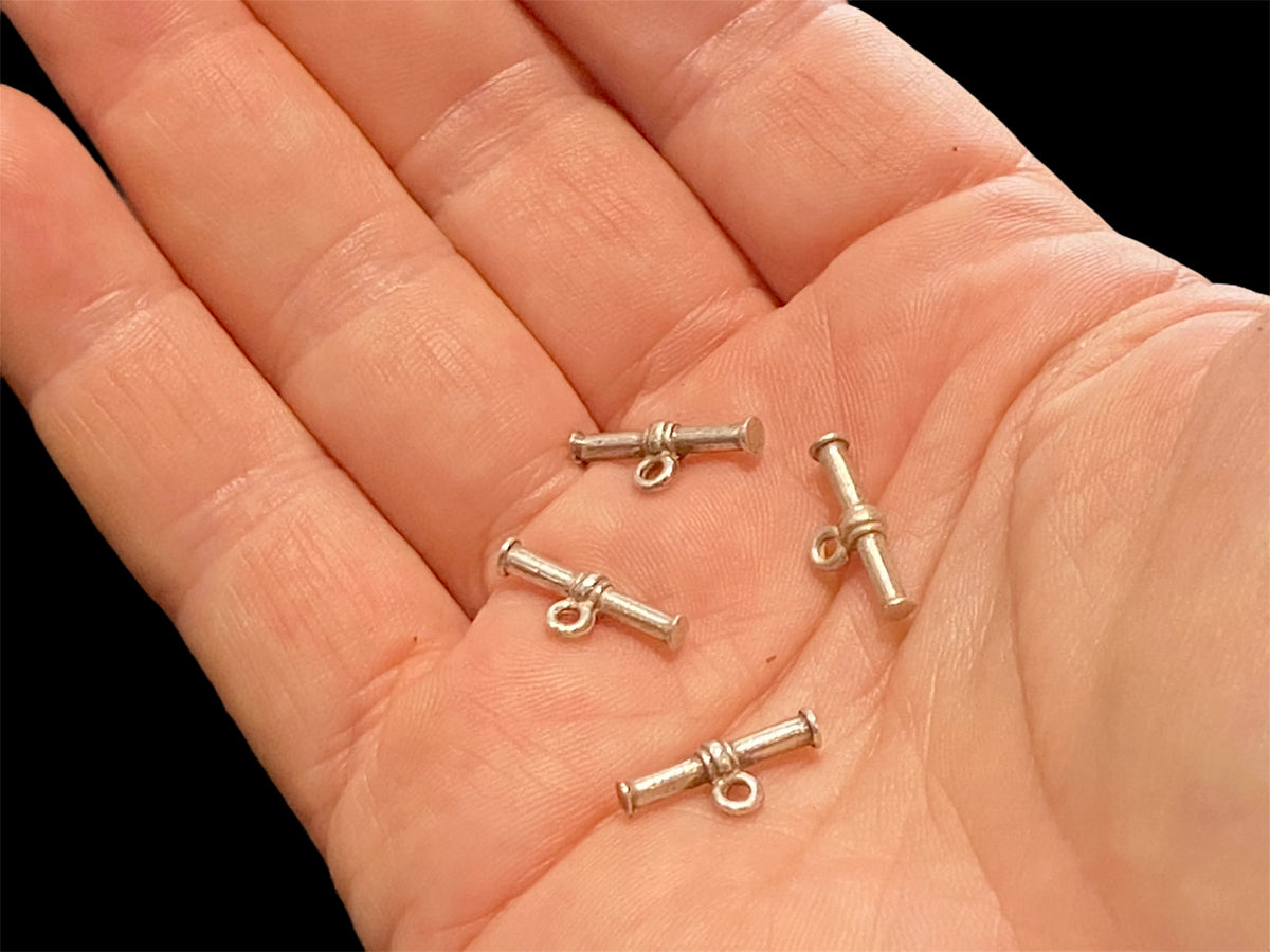 Small sterling silver toggle bars. For finishing necklace ends with toggle clasps. Choose from plain or fancy.

Price is per piece.

Measurements: length 1.8 cm