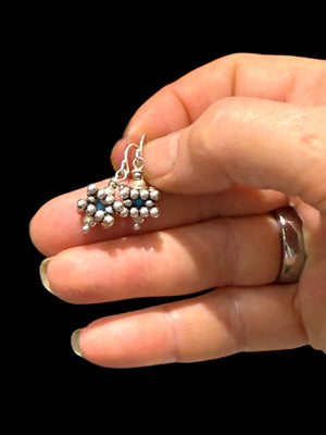 Square geometric earrings feature an open shape with a blue turquoise bead nestled in the very centre. Sterling silver. Measurements: 2.8 cm length including hook