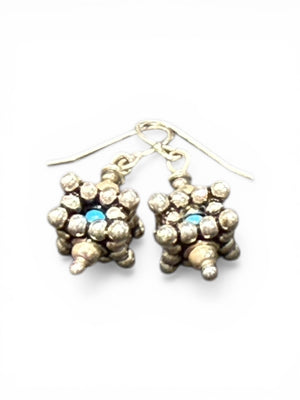 Square geometric earrings feature an open shape with a blue turquoise bead nestled in the very centre. Sterling silver. Measurements: 2.8 cm length including hook