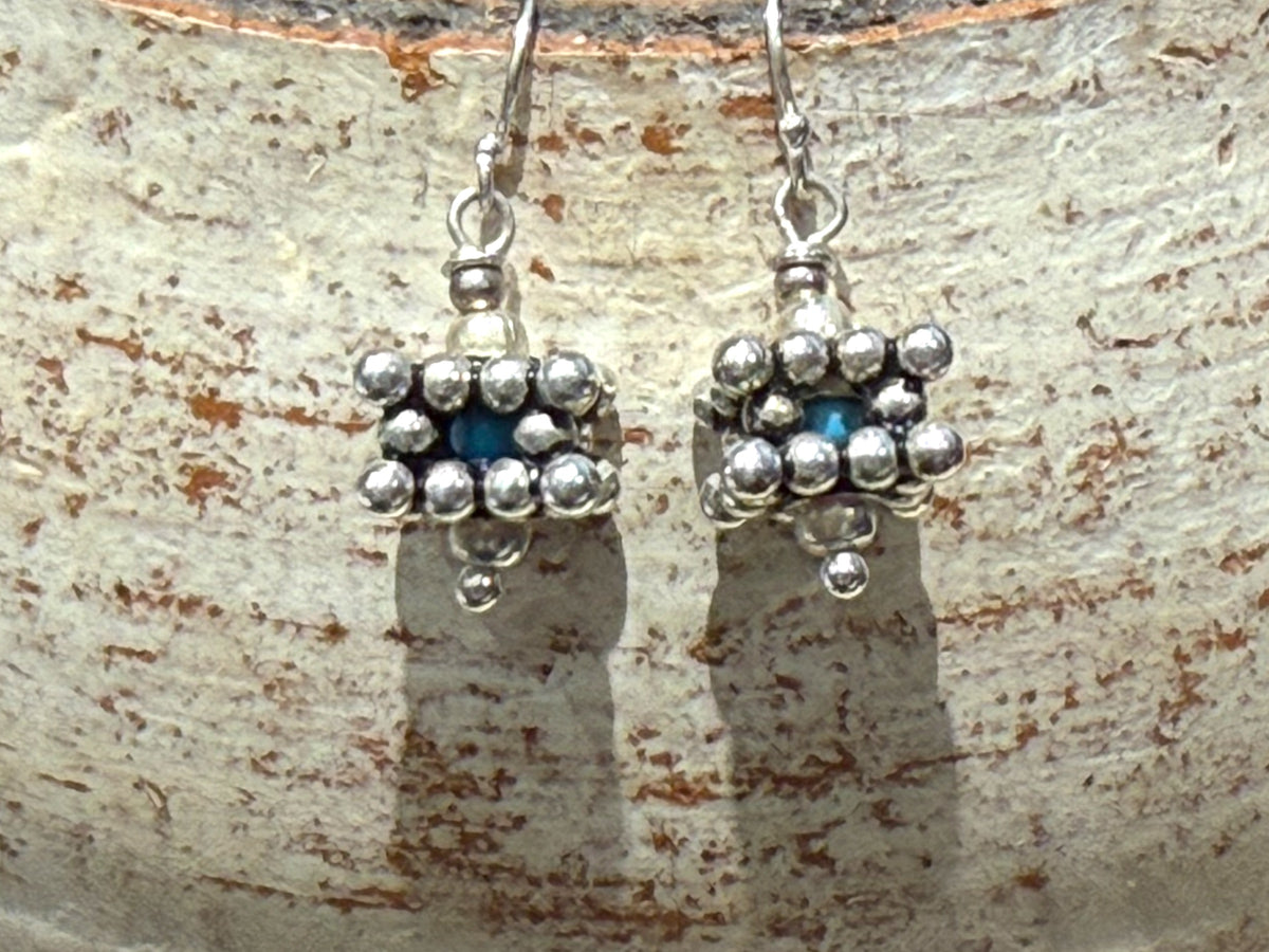 Square geometric earrings feature an open shape with a blue turquoise bead nestled in the very centre. Sterling silver. Measurements: 2.8 cm length including hook