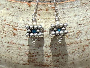 Square geometric earrings feature an open shape with a blue turquoise bead nestled in the very centre. Sterling silver. Measurements: 2.8 cm length including hook