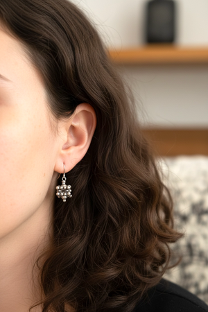 Square geometric earrings feature an open shape with a blue turquoise bead nestled in the very centre. Sterling silver. Measurements: 2.8 cm length including hook