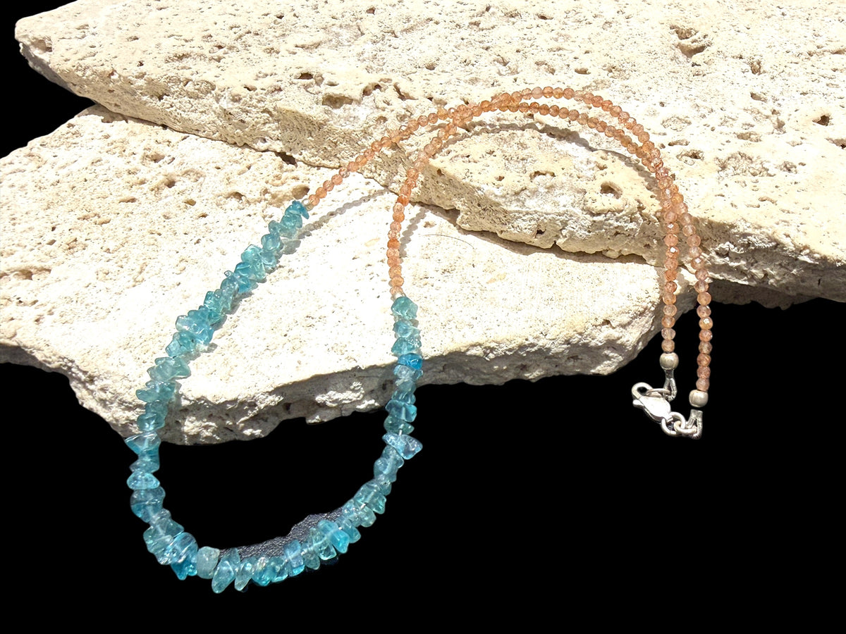Sparkling facet cut sunstone is teamed with aqua blue fluorite to create a unique necklace. Silver bead detailing and a silver lobster clasp, 44 cm length.
