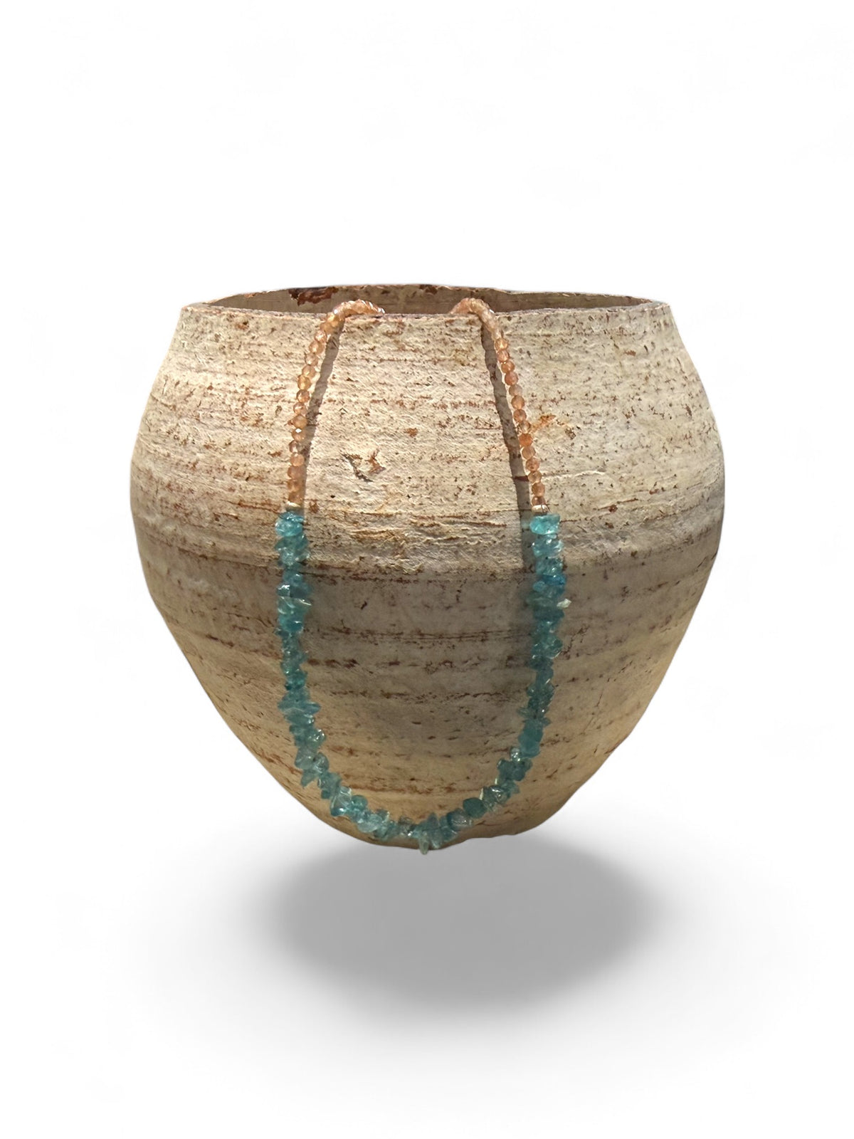 Sparkling facet cut sunstone is teamed with aqua blue fluorite to create a unique necklace. Silver bead detailing and a silver lobster clasp, 44 cm length.
