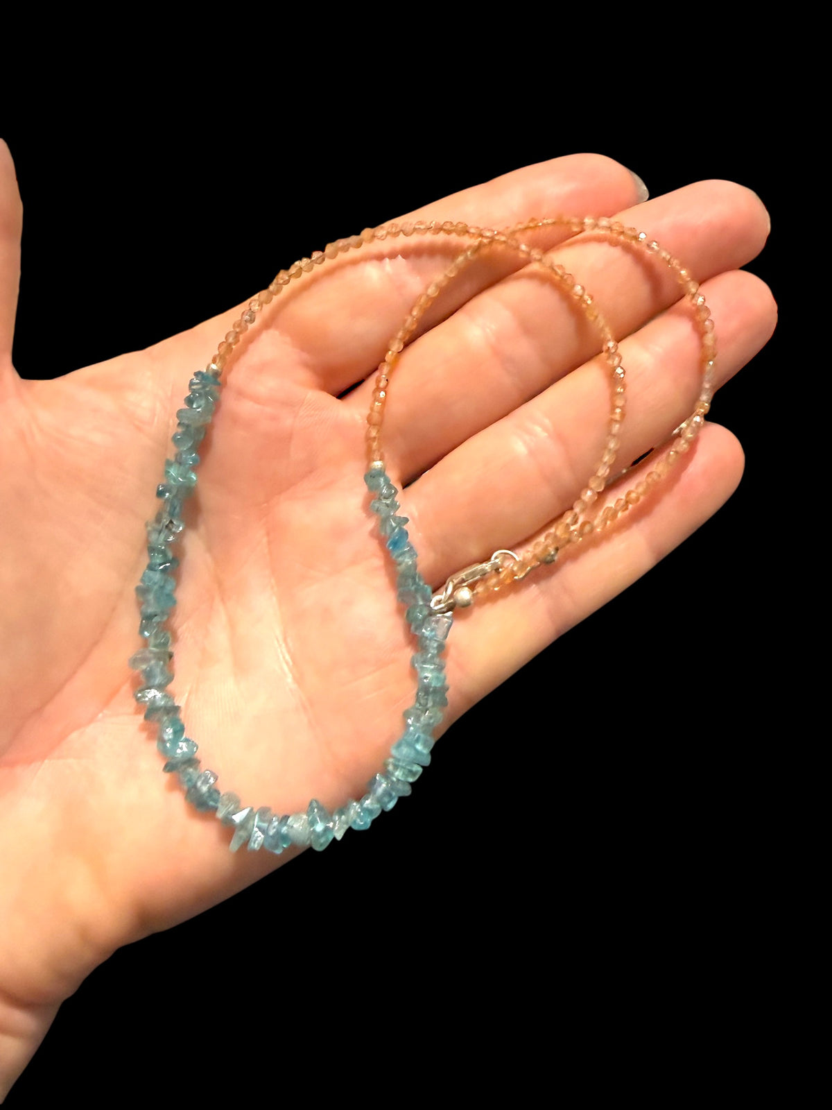 Sparkling facet cut sunstone is teamed with aqua blue fluorite to create a unique necklace. Silver bead detailing and a silver lobster clasp, 44 cm length.
