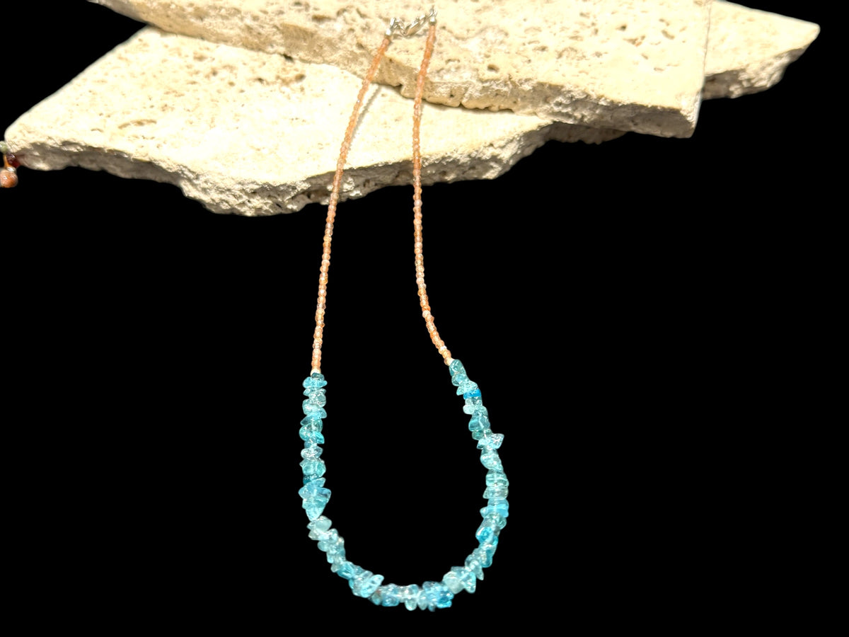 Sparkling facet cut sunstone is teamed with aqua blue fluorite to create a unique necklace. Silver bead detailing and a silver lobster clasp, 44 cm length.

