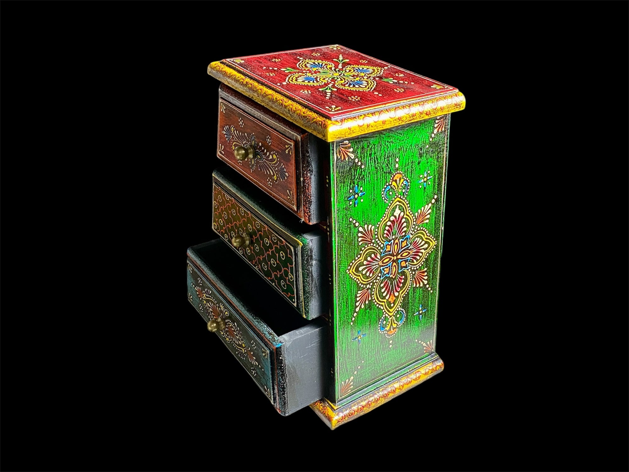 This intricately hand painted box features three drawers and small feet. Brass knobs as handles add a touch of elegance, perfect for holding everything from trinkets to jewellery. Width 21.5, depth 11.5 cm, height 24 cm
