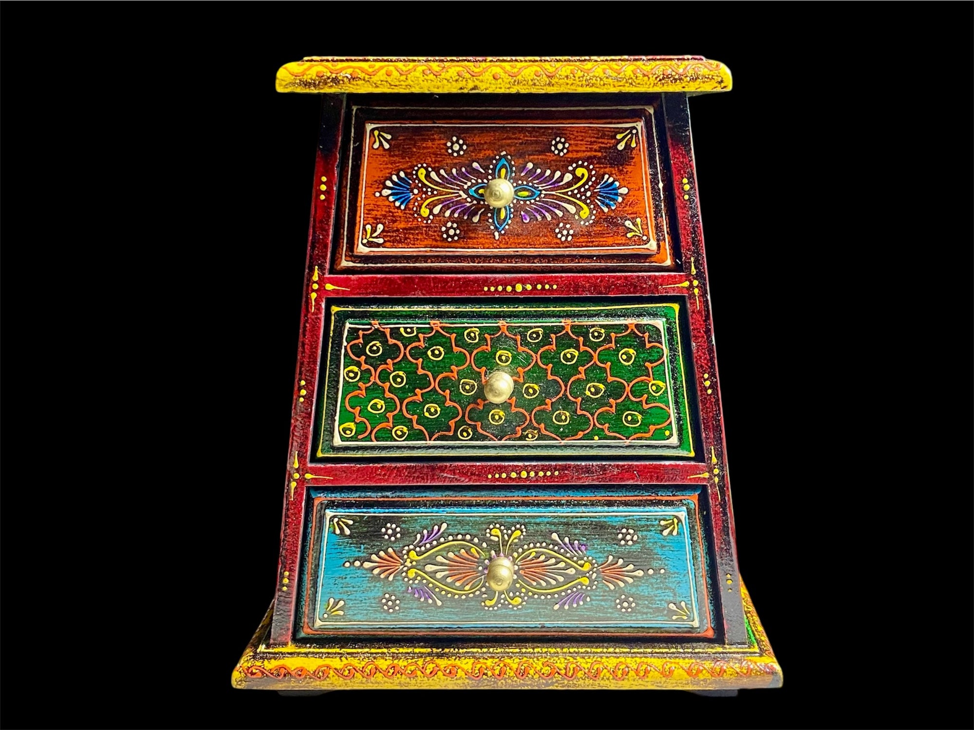 This intricately hand painted box features three drawers and small feet. Brass knobs as handles add a touch of elegance, perfect for holding everything from trinkets to jewellery. Width 21.5, depth 11.5 cm, height 24 cm
